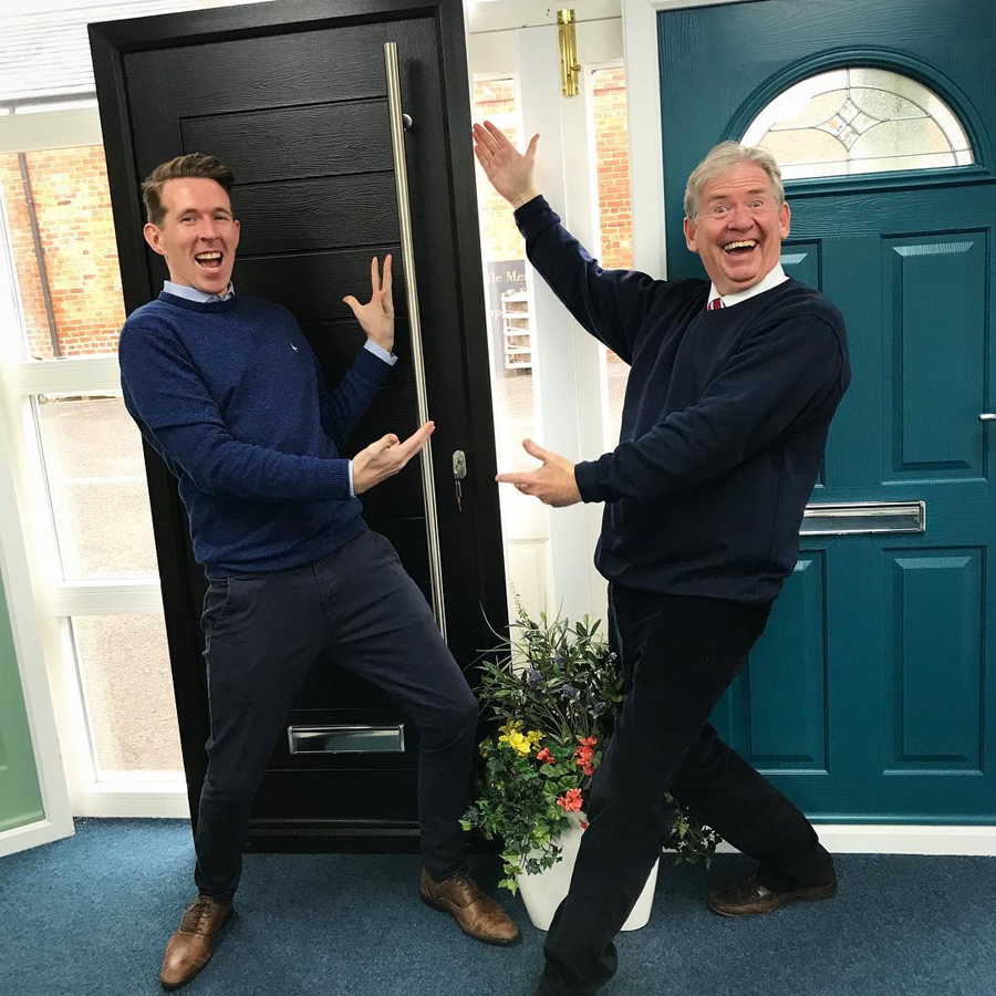 Picture of owners showcasing a door